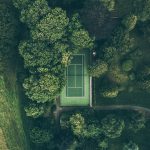 aerial photo of tennis court surrounded with trees