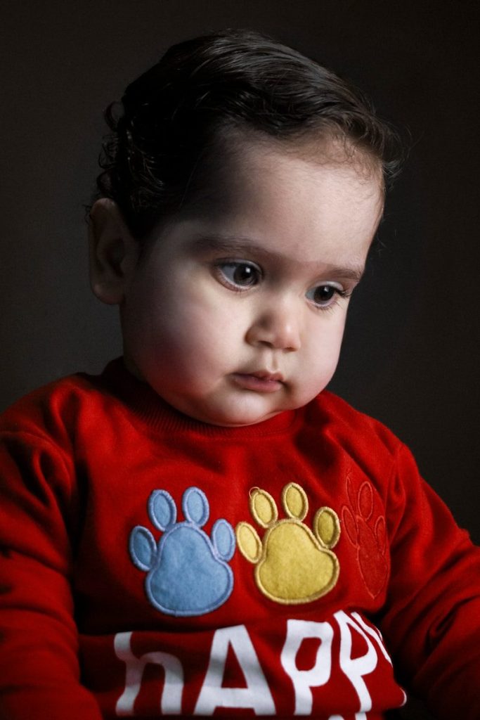 boy in red and blue crew neck long sleeve shirt